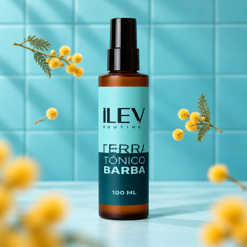 Tónico de Barba ILEV Routine 100 ml sobre fondo de baldosas aqua con ramas de mimosa amarilla